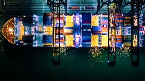 building,indoor,table,water,sitting,light,large,room,harbor,sign,city,standing,bus,night,parked