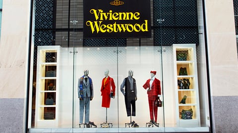 a group of people standing in front of a store