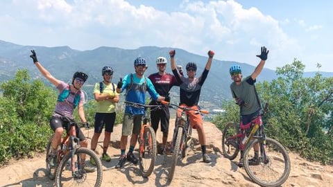 a group of people riding on the back of a bicycle