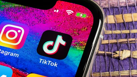 Tik Tok application on mobile phone next to Instagram