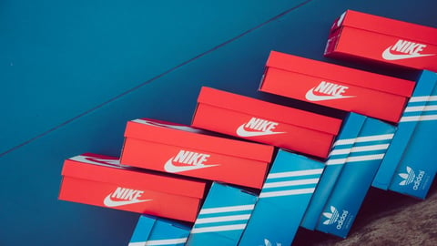 nike and adidas shoe boxes stacked on top of eachother