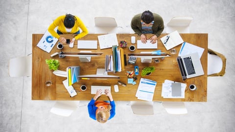 employees sitting at desk working