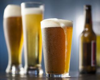a close up of a bottle and a glass of beer on a table