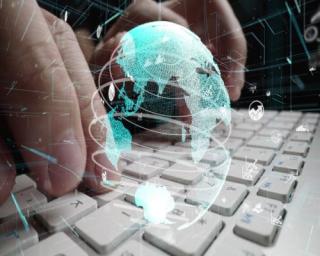 a person sitting on the keyboard of a laptop
