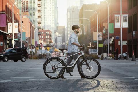 a man riding a bicycle on a city street
