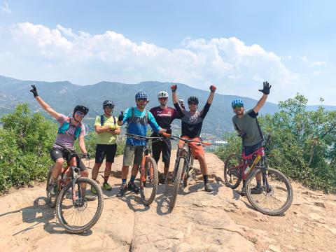 a group of people riding on the back of a bicycle
