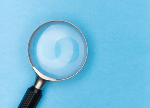Magnifying glass on blue background