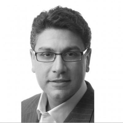 a man wearing glasses and looking at the camera