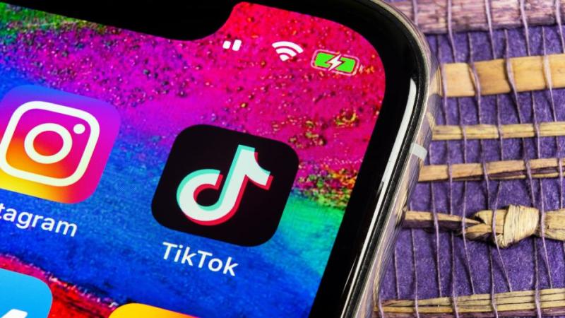 Tik Tok application on mobile phone next to Instagram