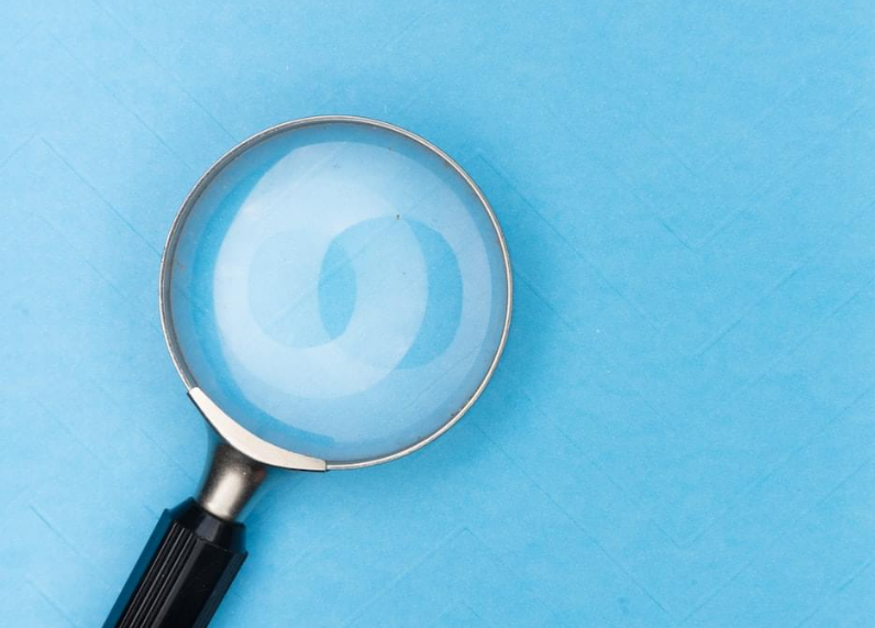 Magnifying glass on blue background
